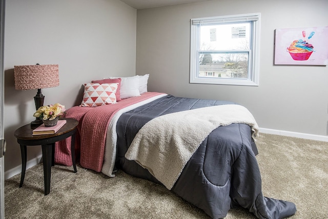 carpeted bedroom featuring baseboards