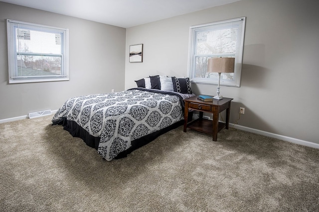 bedroom with carpet floors, multiple windows, and visible vents