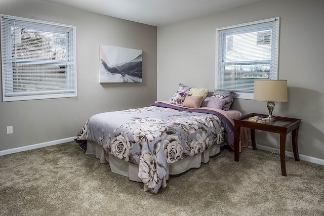 bedroom featuring carpet and baseboards