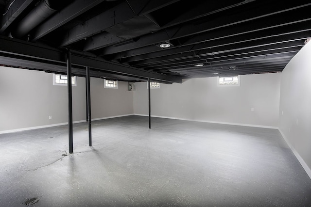 basement with a wealth of natural light and baseboards