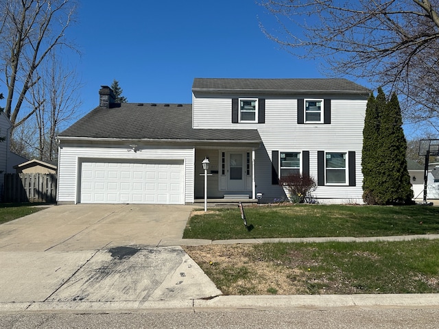 traditional-style home with a front lawn, a chimney, concrete driveway, fence, and a garage