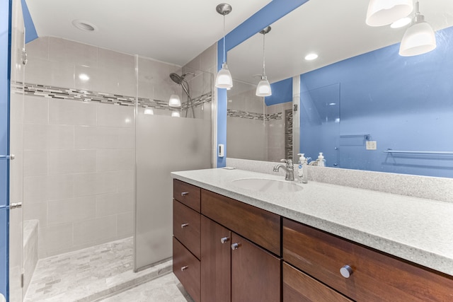 bathroom featuring walk in shower and vanity