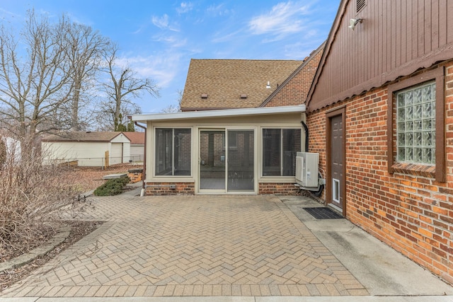 view of patio / terrace featuring ac unit and a sunroom