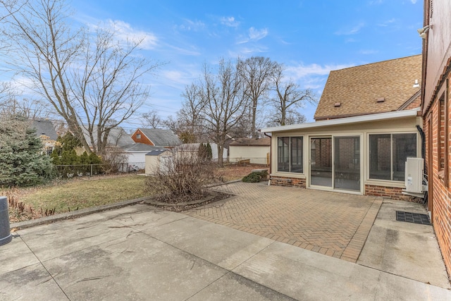 view of patio / terrace with a sunroom and fence