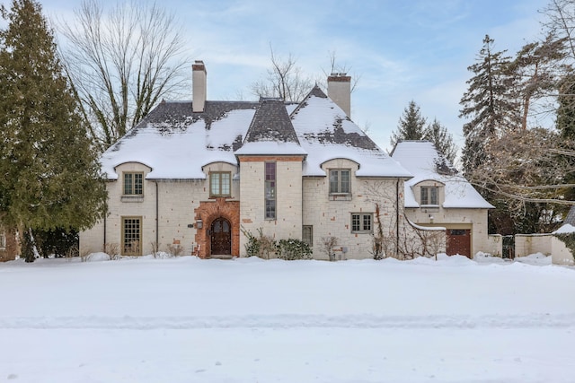 french country style house featuring a chimney