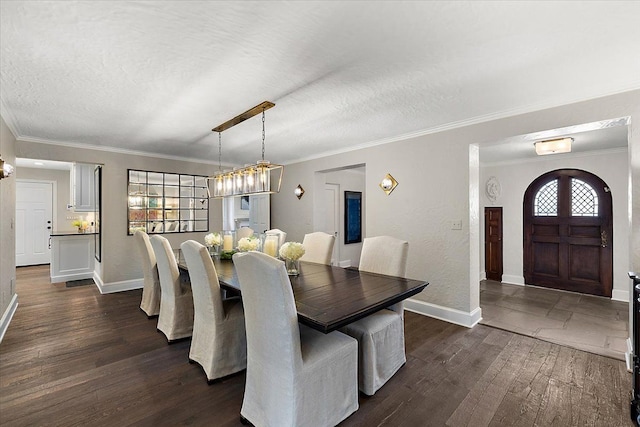 dining room with dark wood-style floors, baseboards, a textured ceiling, and ornamental molding