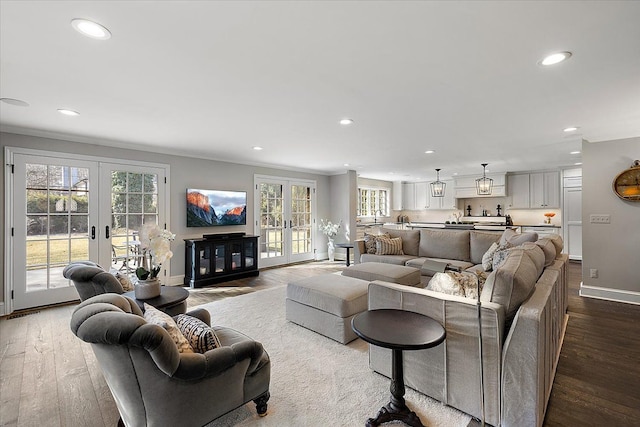 living room with baseboards, french doors, wood finished floors, and recessed lighting