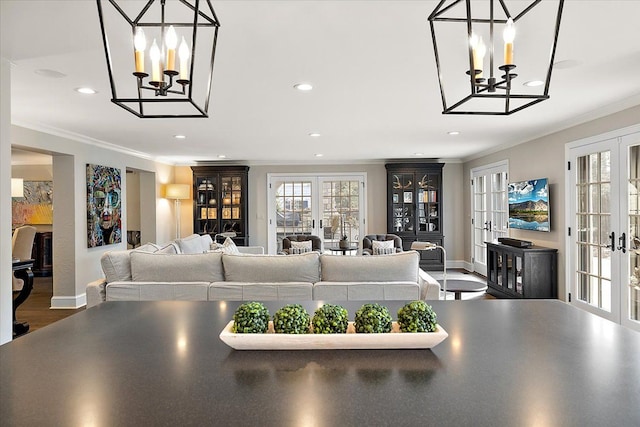 living room featuring ornamental molding, wood finished floors, and french doors