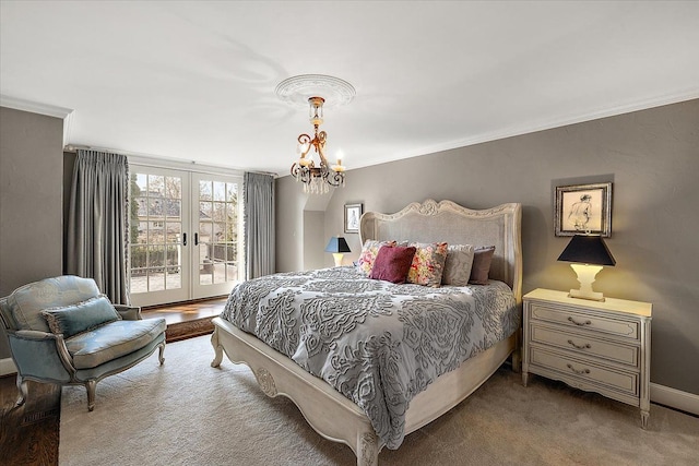 bedroom featuring ornamental molding, an inviting chandelier, access to exterior, carpet flooring, and french doors