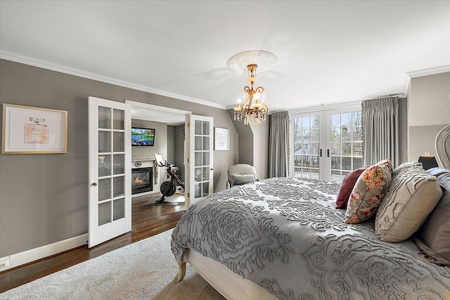 bedroom featuring access to exterior, french doors, crown molding, and wood finished floors