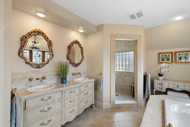 bathroom with double vanity, visible vents, a stall shower, a sink, and tile patterned flooring