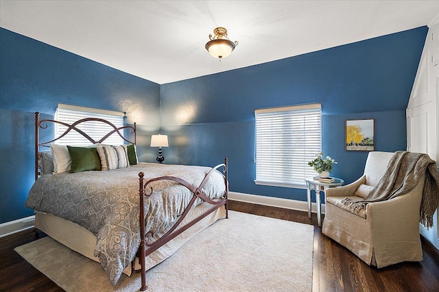 bedroom with baseboards and wood finished floors