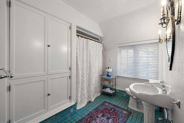 bathroom with curtained shower, toilet, and tile patterned floors