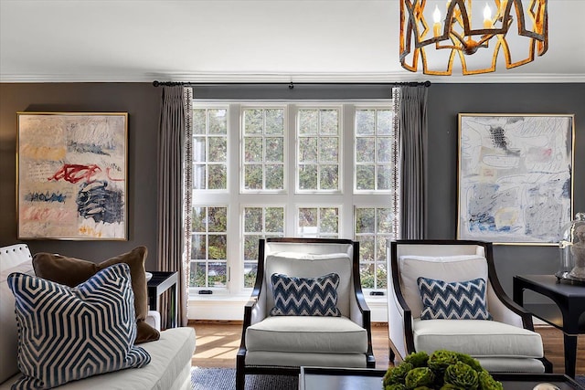 sitting room with a chandelier and ornamental molding