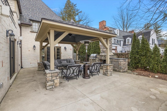 view of patio / terrace featuring exterior kitchen, an outdoor living space, and a gazebo