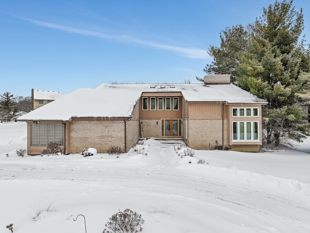 view of front facade featuring french doors and brick siding