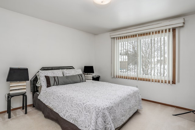 carpeted bedroom featuring baseboards