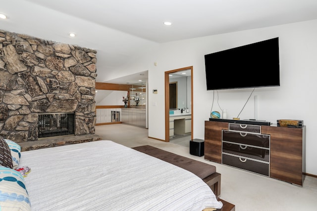 bedroom with a fireplace, lofted ceiling, recessed lighting, ensuite bathroom, and carpet flooring