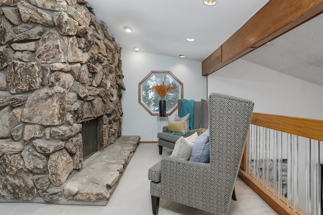 sitting room with recessed lighting, beam ceiling, light colored carpet, and a fireplace