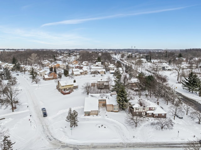 snowy aerial view with a residential view