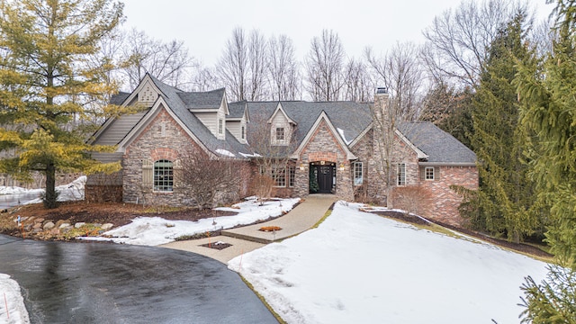 view of front of house with stone siding and driveway