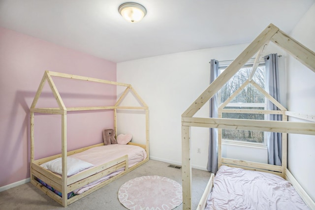 carpeted bedroom featuring visible vents and baseboards