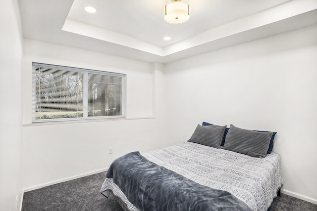 bedroom with carpet floors, baseboards, a raised ceiling, and recessed lighting