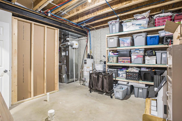 unfinished basement with gas water heater and heating unit