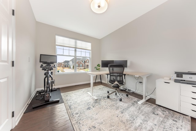 home office with lofted ceiling, baseboards, and wood finished floors