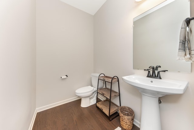 bathroom featuring baseboards, toilet, and wood finished floors