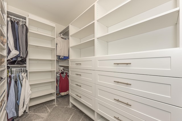 spacious closet featuring dark carpet