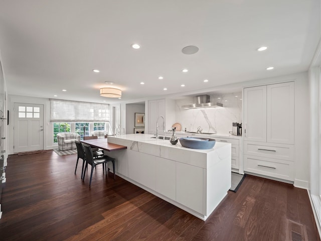 300 Warren Ct, Birmingham, MI 48009 - kitchen featuring white cabinets, recessed lighting, cooktop, dark wood-style floors, and a center island with sink