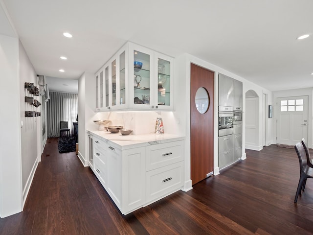 300 Warren Ct, Birmingham, MI 48009 - hall with dark wood finished floors, arched walkways, recessed lighting, and baseboards