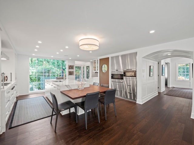300 Warren Ct, Birmingham, MI 48009 - dining room with arched walkways, dark wood finished floors, and recessed lighting