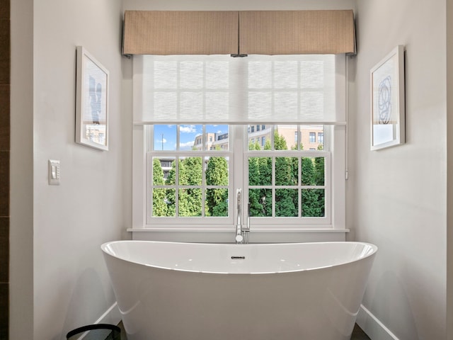 300 Warren Ct, Birmingham, MI 48009 - full bathroom with baseboards and a freestanding bath