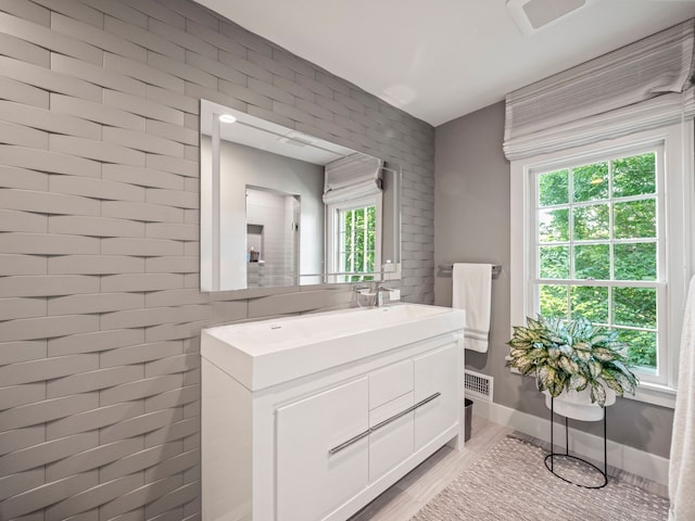 300 Warren Ct, Birmingham, MI 48009 - bathroom featuring wood finished floors, vanity, and baseboards