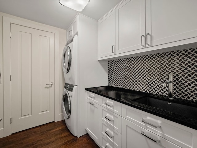 300 Warren Ct, Birmingham, MI 48009 - washroom featuring stacked washing machine and dryer, cabinet space, and dark wood finished floors
