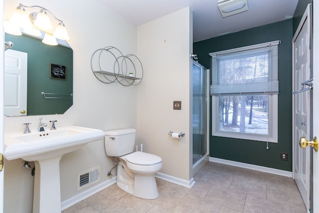 full bathroom with a stall shower, baseboards, visible vents, toilet, and tile patterned floors