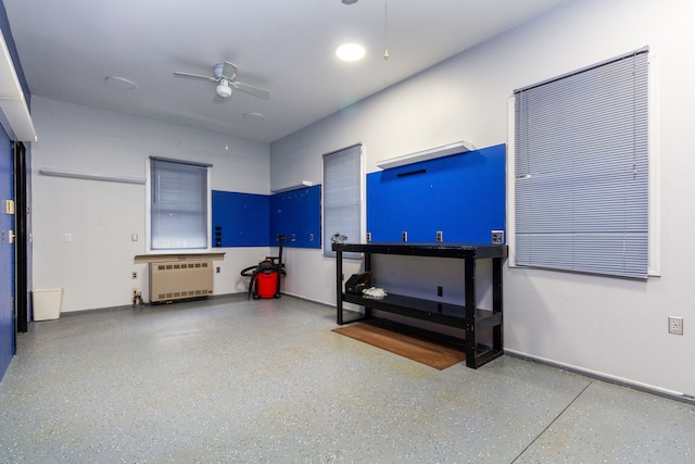 miscellaneous room with a ceiling fan, radiator, baseboards, and speckled floor