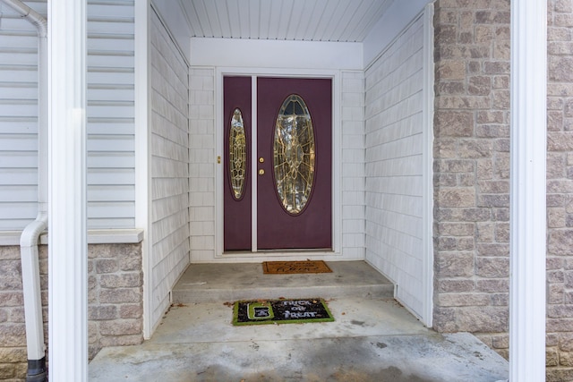 property entrance with stone siding