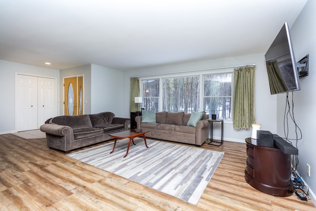 living room featuring wood finished floors and baseboards