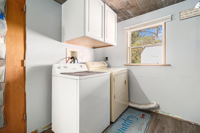 clothes washing area featuring wood ceiling, cabinet space, independent washer and dryer, and wood finished floors