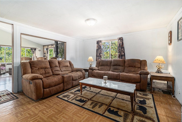 living room with a healthy amount of sunlight and lofted ceiling