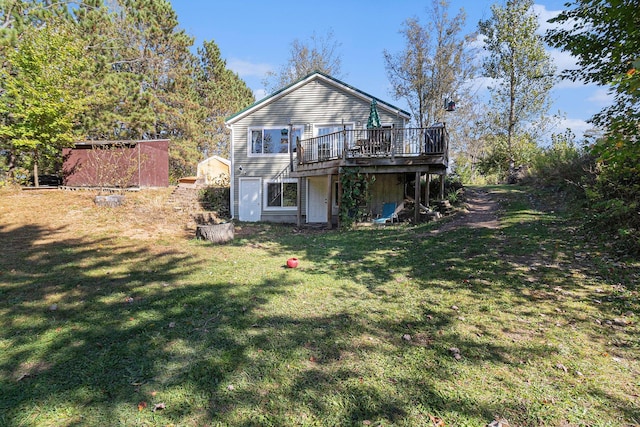 rear view of house featuring a deck and a yard