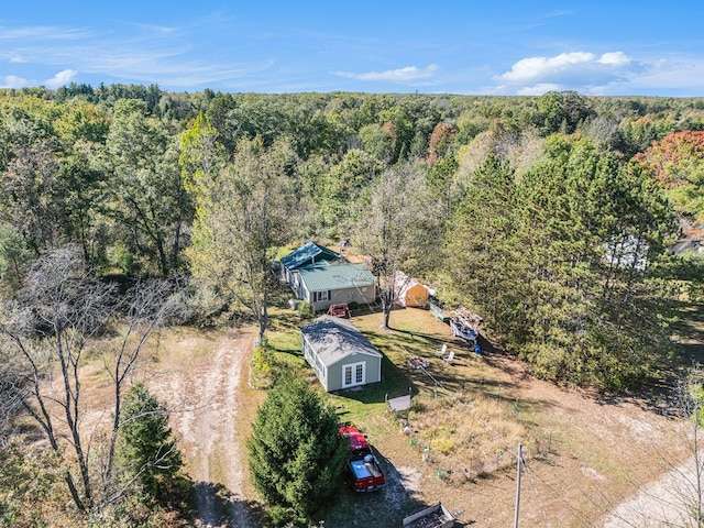 birds eye view of property featuring a wooded view