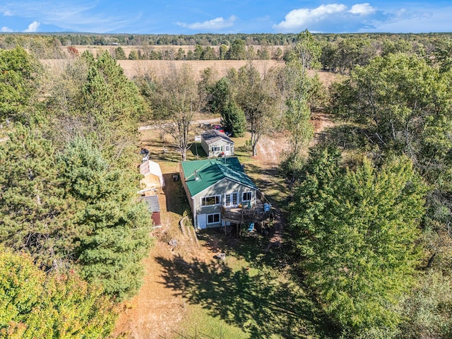 bird's eye view with a wooded view