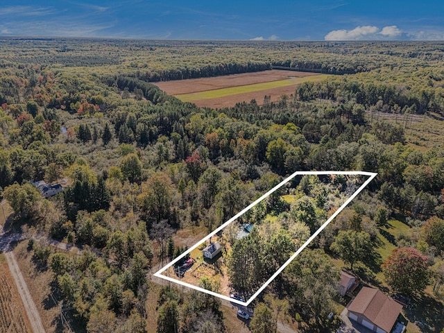 birds eye view of property featuring a view of trees