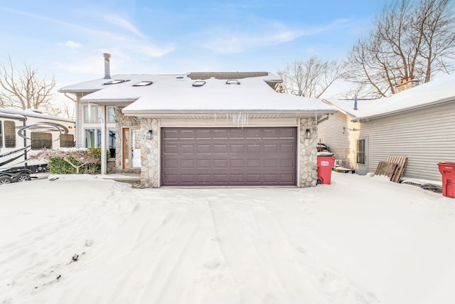 view of front of house featuring stone siding and an attached garage