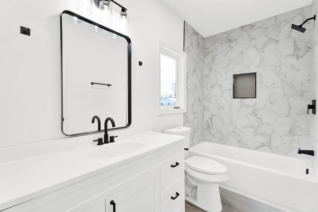 bathroom featuring bathing tub / shower combination, vanity, and toilet