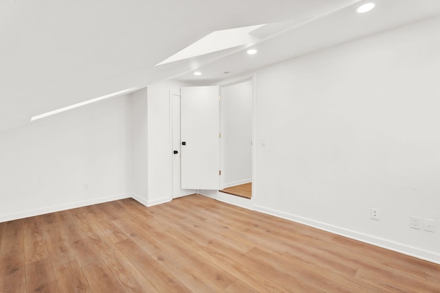 additional living space featuring light wood-style floors, baseboards, and recessed lighting